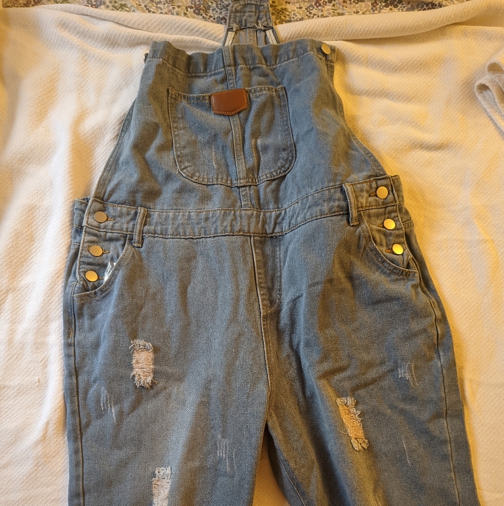 Women's full length distressed denim overalls